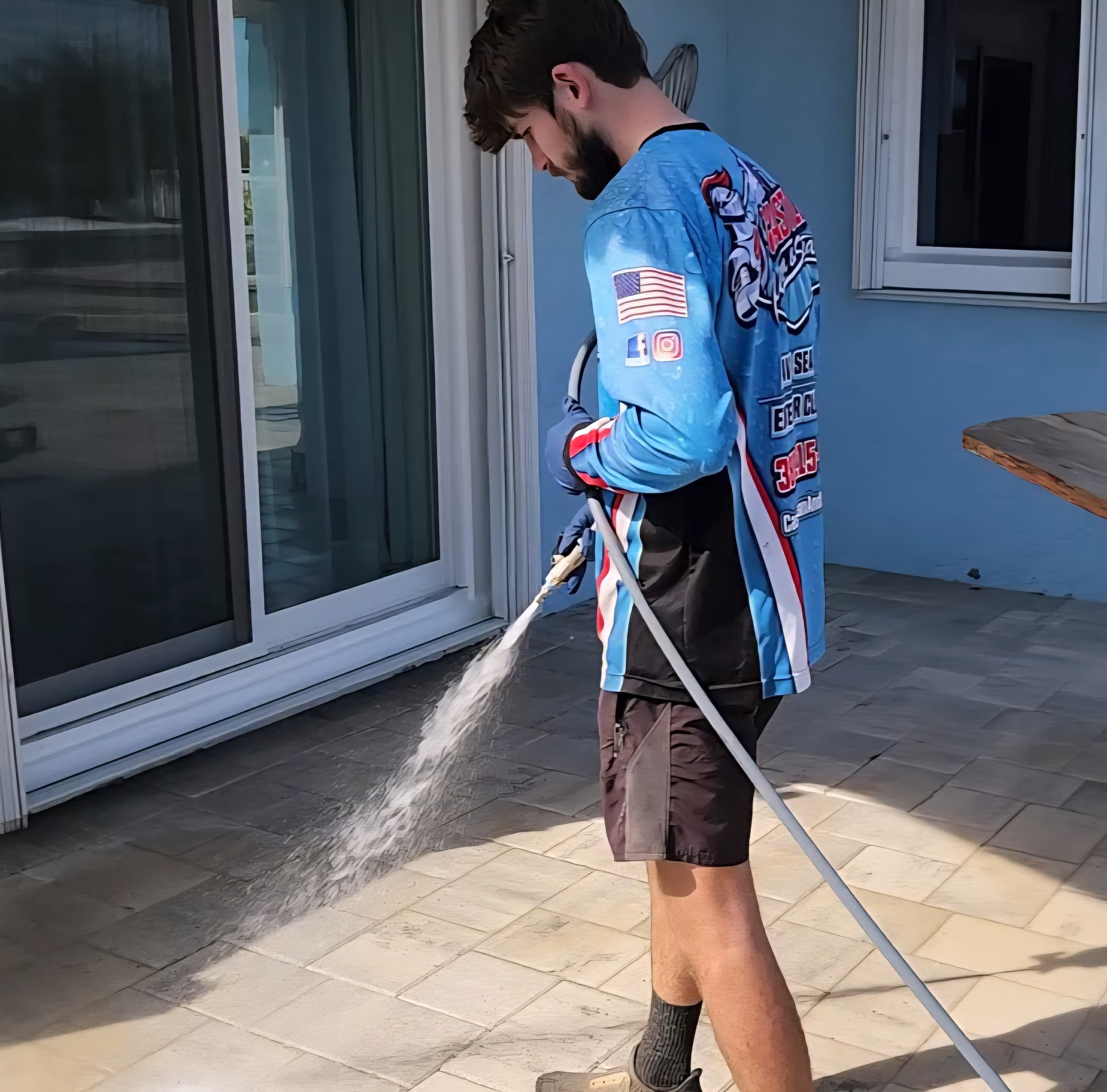 Pressure washing operator transforming a driveway